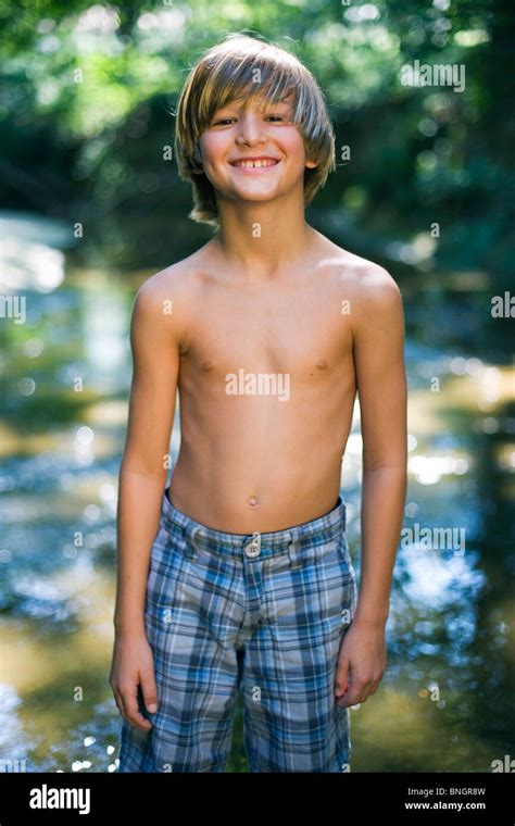 Portrait Of Boy Standing Near Creek Stock Photo Alamy