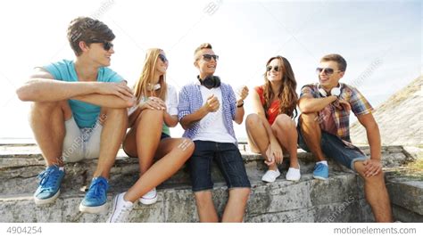 Group Of Smiling Teenagers Hanging Out Outdoors Stock Video Footage 4904254