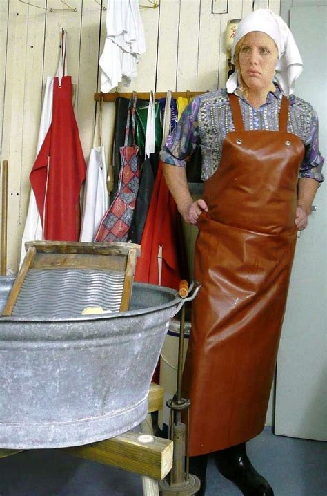 A Woman In An Apron Standing Next To A Metal Tub