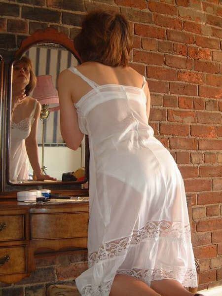 another classic white slip that s sheer enough to show the other lingerie she has on underneath