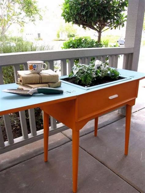 I have an old singer cabinet style sewing machine and i would like some ideas of how to utilize it other than using it as an end table with a cloth covering it. Old sewing table turned colour popping planter | The Owner ...
