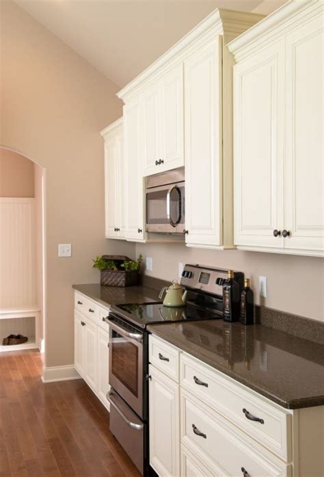 Create a kitchen design that is functional and attractive. Kitchen with white cabinets and stainless steel appliances ...
