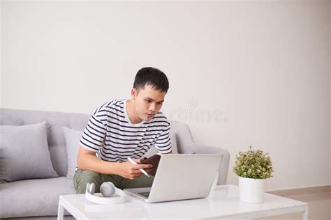 Asian Man Sitting On Couch With Laptop Stock Photo Image Of Sofa
