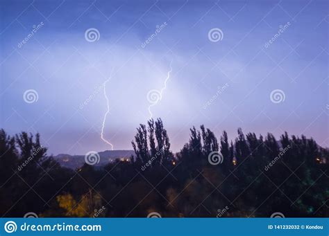 Night Lightning Storm Over City In Blue Dramatic Lighting Stock Photo