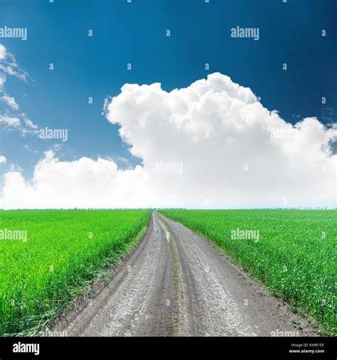 Road In Green Field And White Clouds With Deep Blue Sky Stock Photo Alamy