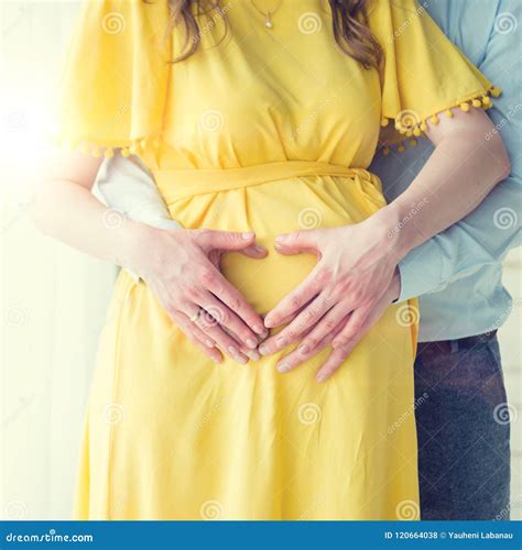 Belly Of A Pregnant Woman Hands Of Parents Hugging A Belly Stock Photo