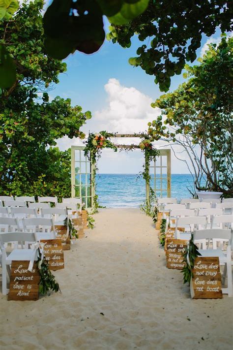 Beach Wedding Ceremony With Door Arch And Wooden Aisle Marker Signs