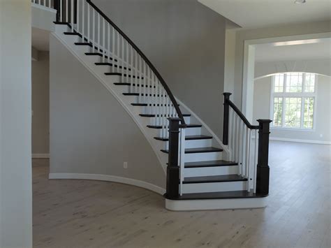 Graceful Curving Staircase Dark Wood White Trim Light