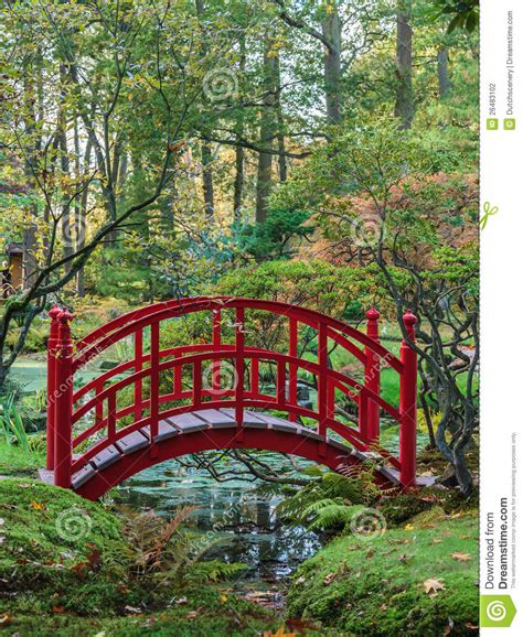 Red Japanese Bridge In An Autumn Garden Stock Photo