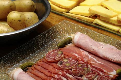 Raclette Cheese With Meats Ham Sausage And Potatoes Stock Image