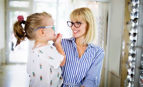 Mother And Daughter In Optician Shop Buying Eyeglasses Stock Image Image Of Frame Mother
