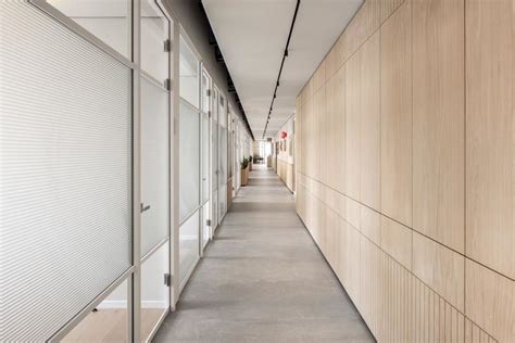 An Empty Hallway Between Two Buildings With Wood Panels On The Walls