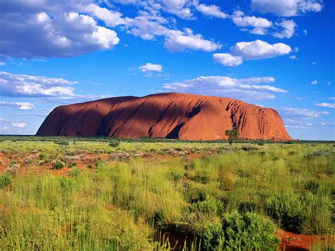 In the central desert, a vast sandstone monolith rises from an endless flat plain, its. Uluru-Kata Tjata National Park / Australia wallpapers and ...