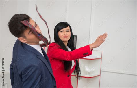 Portrait Of Young Business Woman Giving A Slap In The Face To Stock