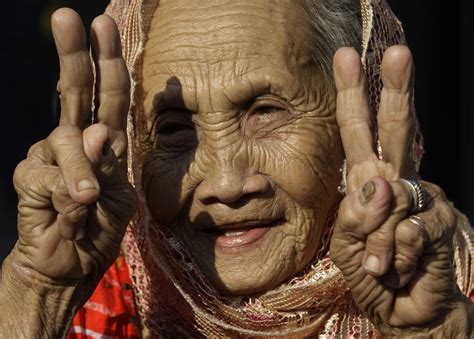A Filipino Muslim Woman Flashes Peace Signs Following A Philippines