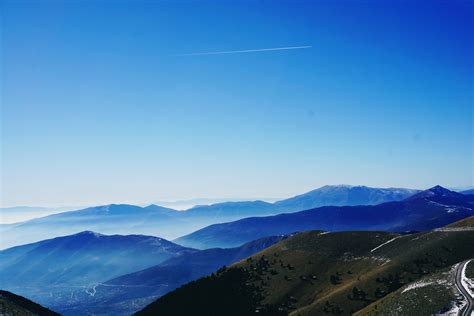 Free Photo Green And Blue Fog Covered Mountains Under Blue Sky