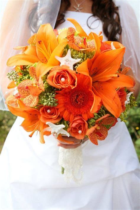 If you love the idea of seashell bridal bouquets but want to also blend in some fresh flowers, you're in luck because it's very easy to have the best of both worlds. Beach Wedding with orange and green flowers. Starfish ...