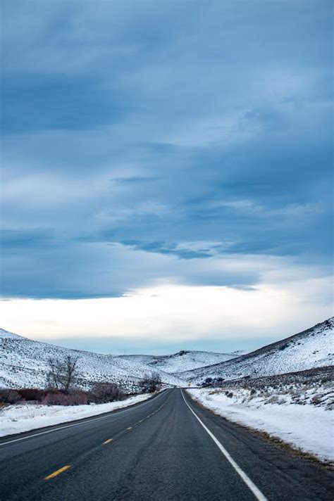 Gray Asphalt Road Between Mountains · Free Stock Photo