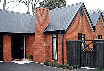 The impact of red brick and your roof color. Image result for modern red brick, black aluminum, dark ...