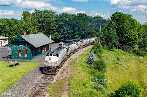 Five Locomotives With Grain Train Passing Through Small Rural Town