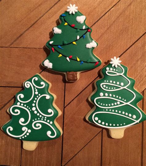 Decorated cookies and royal icing or buttercream piped cookies. Simple Christmas tree cookies, sugar cookies, Christmas ...