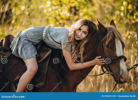 A Young Beautiful Woman Rides A Horse In The Forest In Autumn