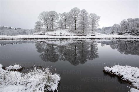 Refelctions In The River Brathay After An Overnight Fall Of Snow In The