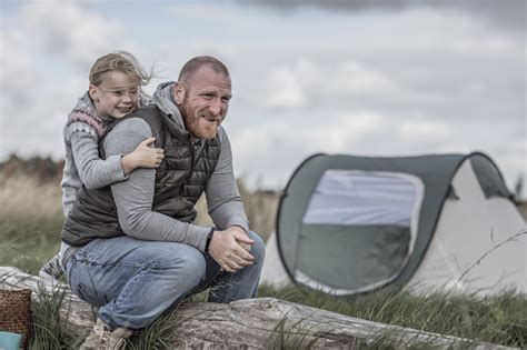 Handsome Redhead Father And Blonde Daughters Enjoying A Camping Holiday Despite The Wintry