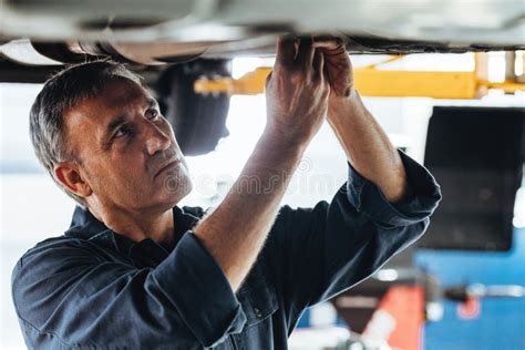 Auto Mechanic Fixing A Car In Service Station Stock Photo Image Of