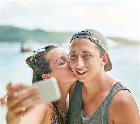 Selfie Loving Shot Of A Happy Couple Taking A Selfie On The Beach