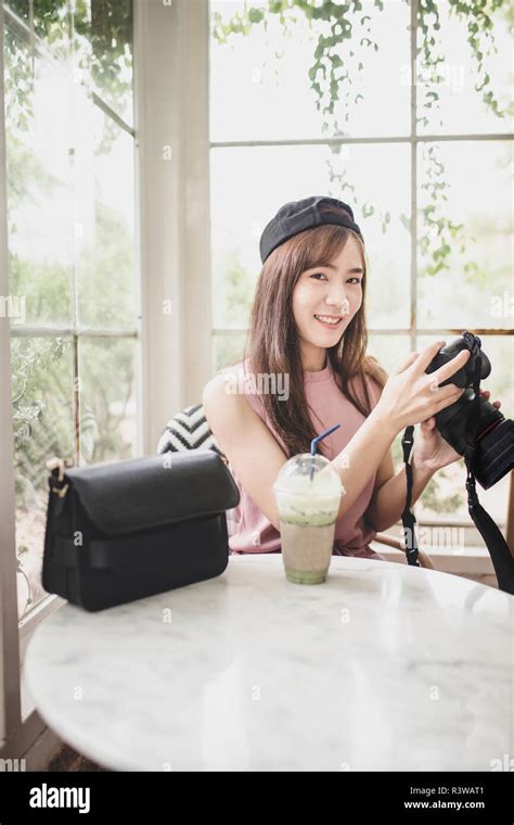 Portrait Younger Asian Woman Relaxing Holding Dslr Camera In Hand Stock