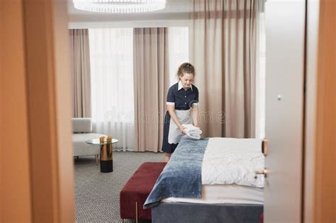 Housekeeper Cleaning Hotel Room And Setting Up Towels Stock Image