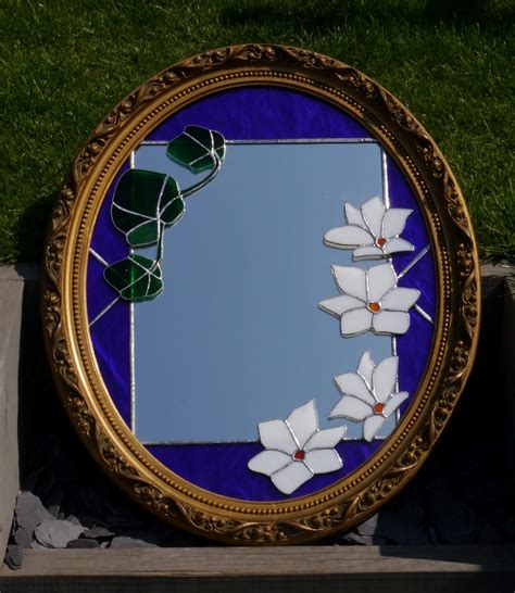 The mirror features beachy blue and cream tones with a distressed wood keeping a coastal, light theme. Stained Glass Blue Mirror | Pia's Panes | Gilt framed mirror