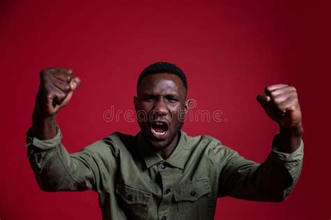 Angry Black Man With Fists Raised On Isolated Background Stock Photo