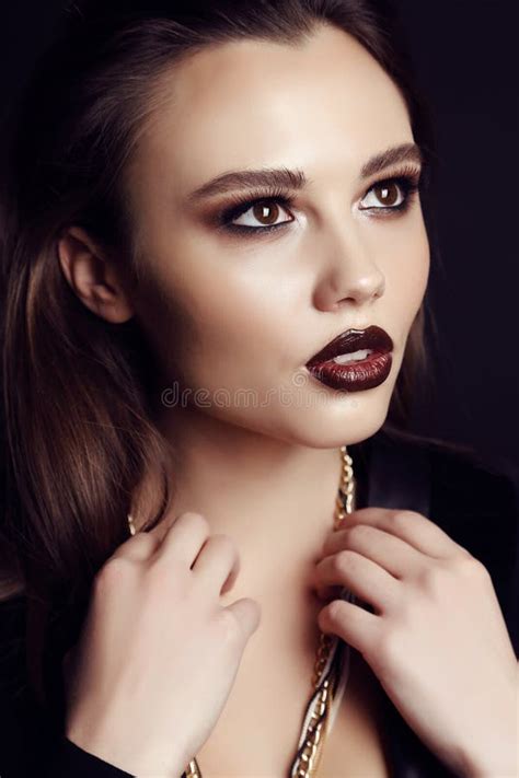Gorgeous Young Woman With Dark Hair And Extravagant Makeup Stock Photo