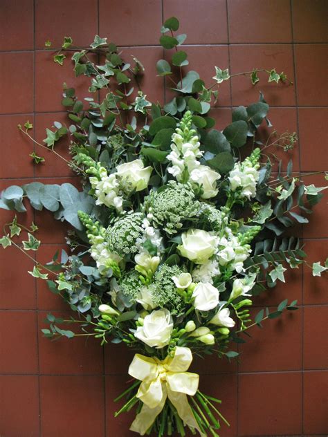 Our professional florists have created this design with a blend of white blooms including lilies, giant chrysanthemums, long stem roses and. A flat bouquet or spray work well as the main piece on the ...