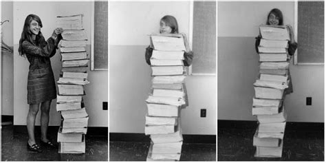 Margaret Hamilton Poses Next To A Huge Stack Of Code She Wrote By Hand