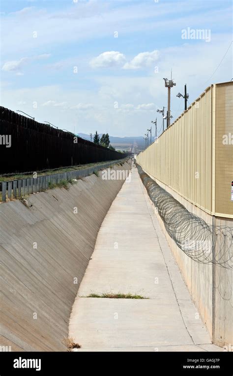 A Culvert Runs Along The International Border Wall Between Agua Prieta