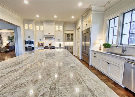 The light countertops add just the materials provided by rai: The island countertop is Taj Mahal quartzite | Grand ...