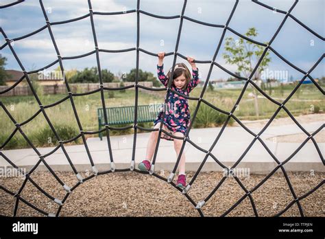 Carefree Girl Playing On Rope At Playground Stock Photo Alamy