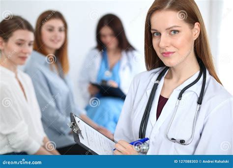 Young Beautiful Female Doctor Smiling While Consulting Her Patient