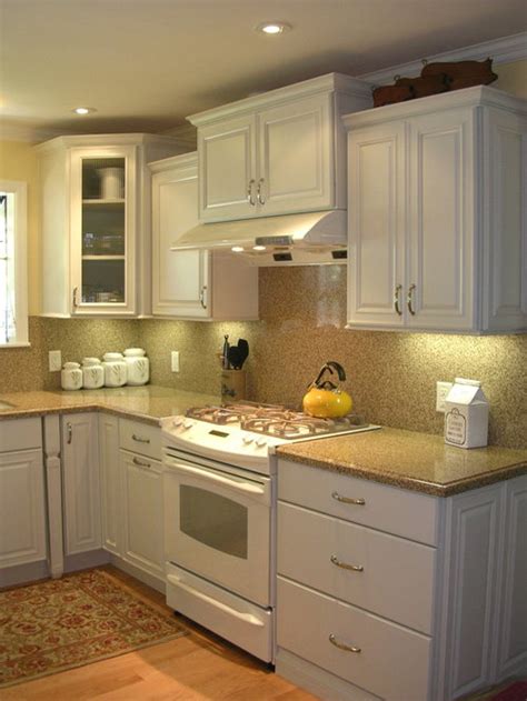 The space features custom cabinetry and an. Small White Kitchen | Houzz