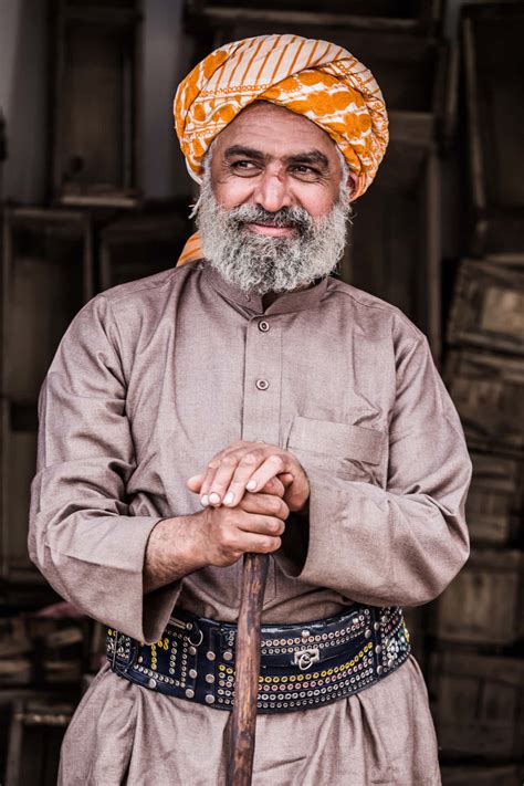 Download Smiling Old Arab Man Wearing Turban Wallpaper