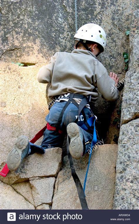 Back Of Male Little Boy Climbing A Rock Of Mountain Stock Photo Alamy