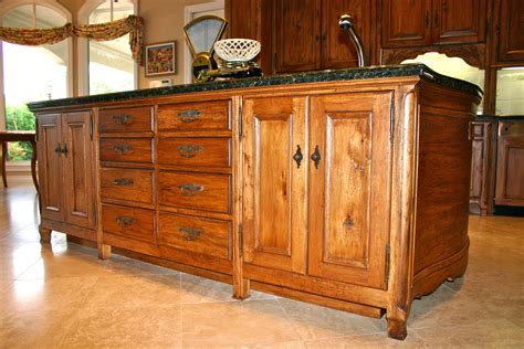 Large kitchen island in Country French kitchen with hand-carved details