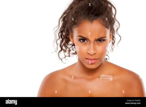 Portrait Of A Beautiful Young Dark Skinned Scowling Woman On A White