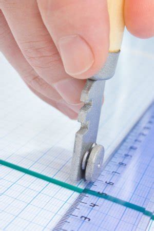 Use a safety glass cutter to score the surface: How to Cut Glass - Bob Vila