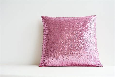 A Pink Pillow Sitting On Top Of A White Shelf