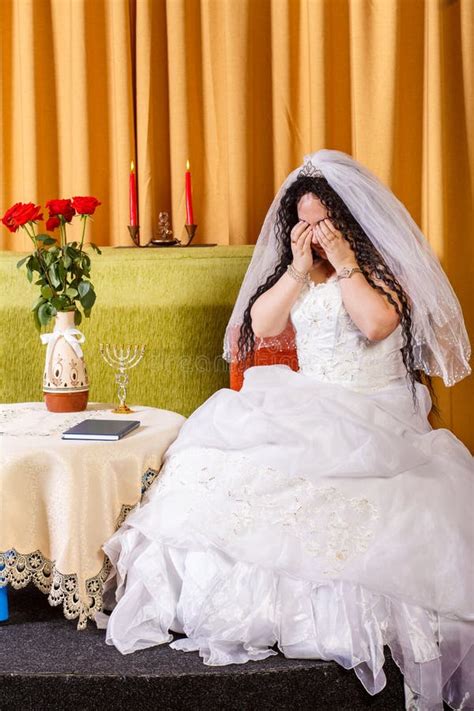 Jewish Bride In A Wedding Dress With A Veil Sits In A Room Crying Her Groom Left Her Before The