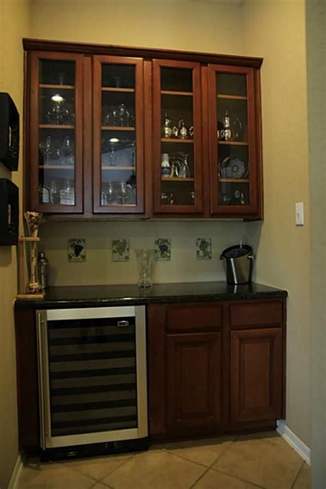 Glass front kitchen cabinets pictures. The bar area has glass front cabinets and a wine ...